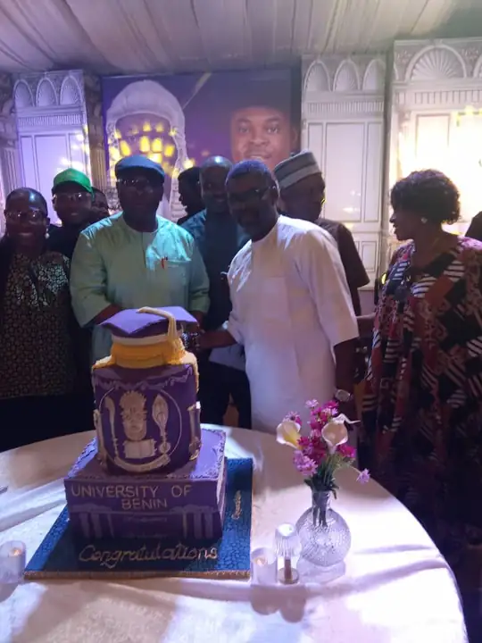 A decorated cake being cut at an EGSOSA celebration